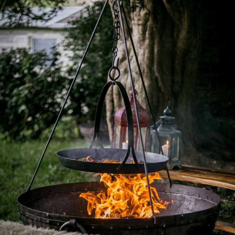 Tripod and skillet cooking over a Kadai fire pit