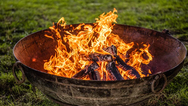 Friends gathered around a Kadai fire pit